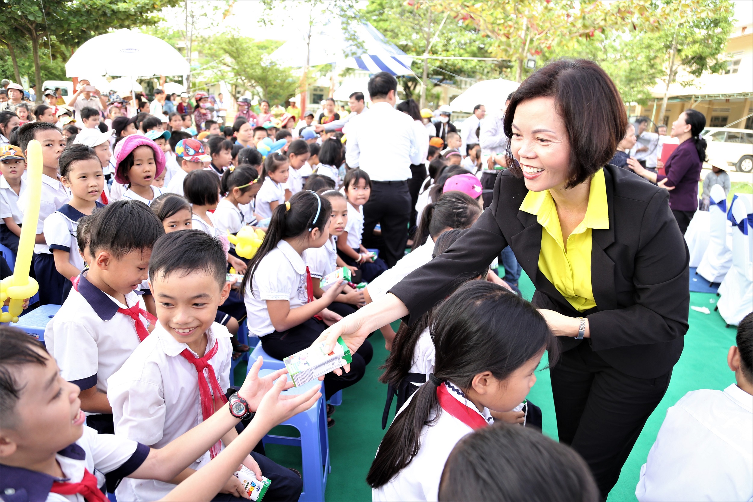  Bà Bùi Thị Hương – Giám đốc Điều hành Vinamilk trao sữa cho các em học sinh.