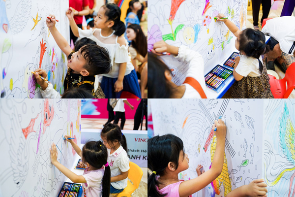 Các em nhỏ đang cùng nhau tô màu bức tranh khổng lồ về Xứ Sở Cầu Vồng mơ ước.