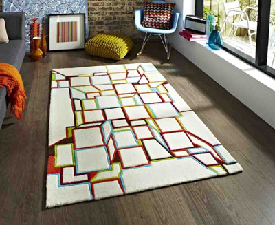 Tấm thảm hình học với những gam màu sặc sỡ tạo thành các khối hình trên nền thảm bông trắng.